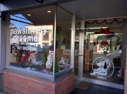 Pet Groomer salon storefront in Burlingame, San Mateo County, with holiday decorations and a dog illustration on the window.